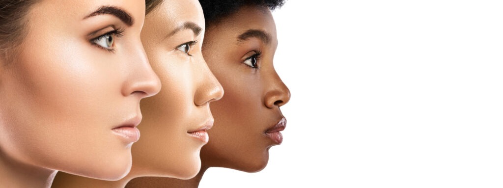 Three women of diverse ethnic backgrounds face left, showcasing their profiles. The image highlights beauty and cultural diversity.